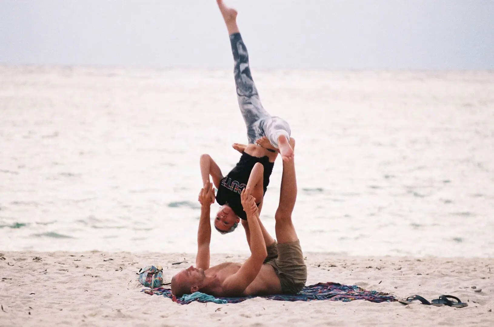 Couple Doing Yoga on the Beach Couple Doing Yoga on the Beach